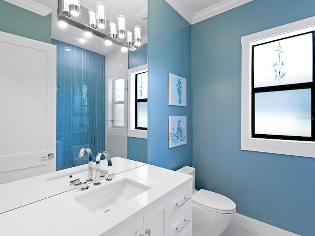 bathroom featuring crown molding, vanity, toilet, and a shower with shower door