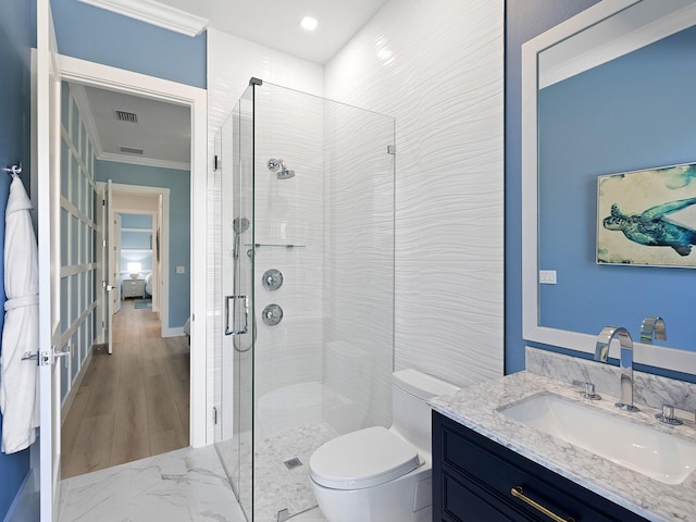 bathroom with walk in shower, ornamental molding, vanity, and toilet