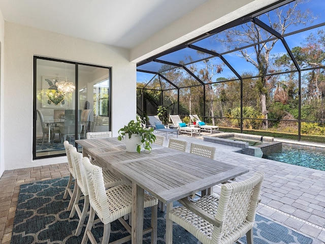 view of patio featuring a swimming pool with hot tub and a lanai