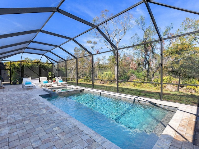 view of swimming pool with an in ground hot tub, a patio, and glass enclosure