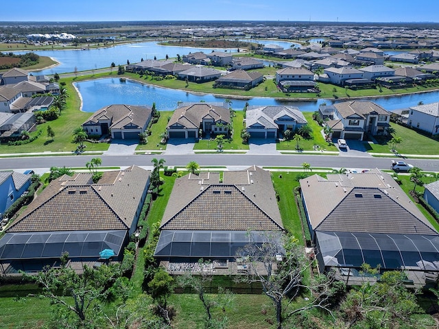 drone / aerial view with a water view and a residential view