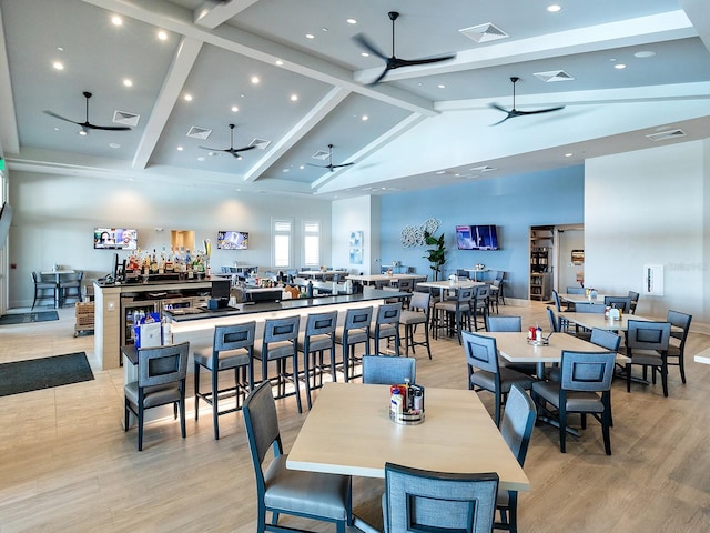 dining space featuring a ceiling fan, visible vents, and beam ceiling