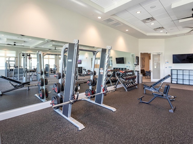 gym featuring a paneled ceiling and a high ceiling