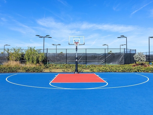 view of basketball court featuring community basketball court and fence