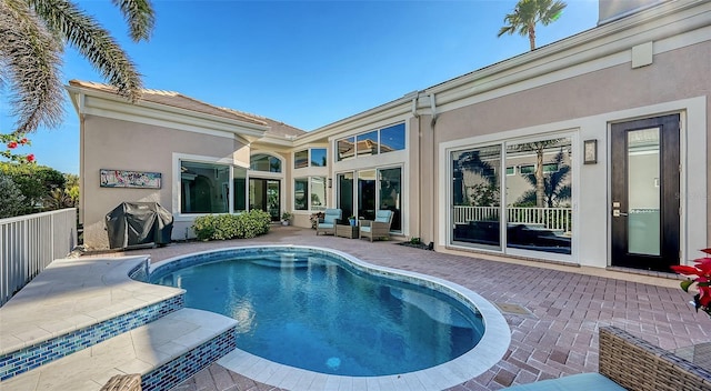 view of pool with a grill and a patio area