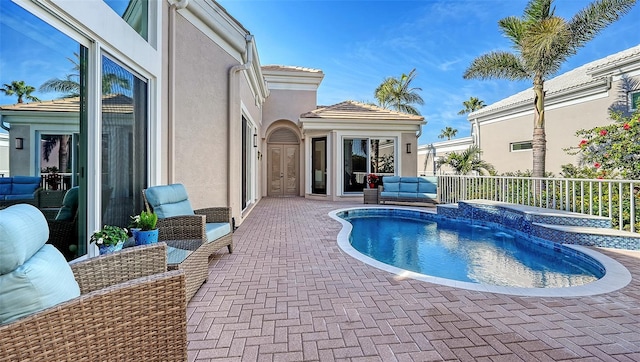 view of swimming pool with a hot tub and a patio area