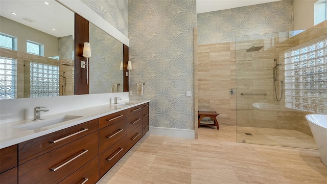 bathroom with tiled shower and vanity