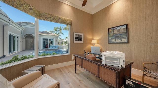 office area with crown molding and light wood-type flooring