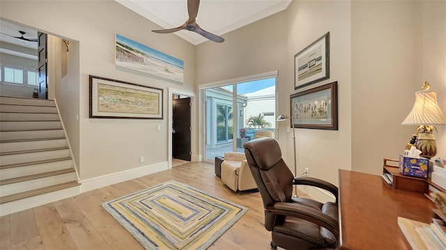 office space featuring a high ceiling, wood-type flooring, and ceiling fan