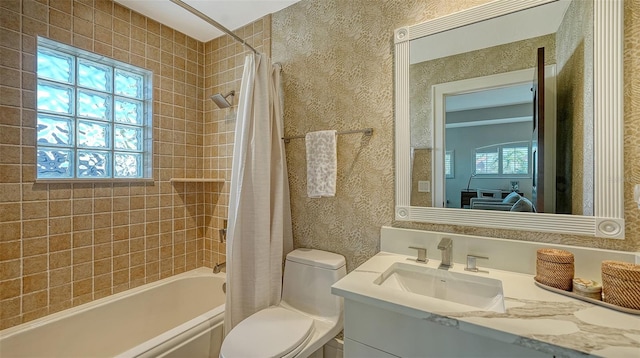 full bathroom featuring shower / tub combo with curtain, vanity, and toilet