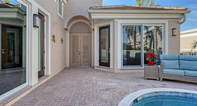 entrance to property featuring a patio