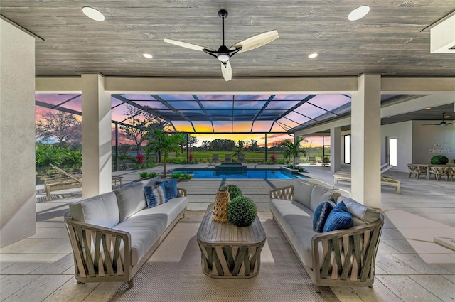 patio terrace at dusk featuring a lanai and outdoor lounge area