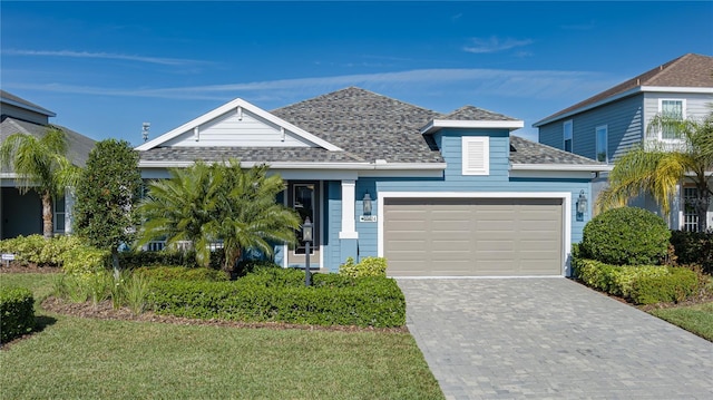 view of front facade featuring a garage and a front lawn