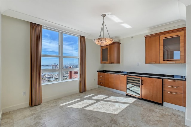 kitchen featuring a water view, decorative light fixtures, and wine cooler