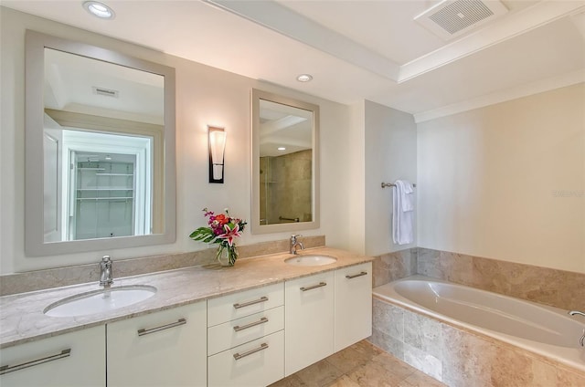 bathroom with vanity and a relaxing tiled tub