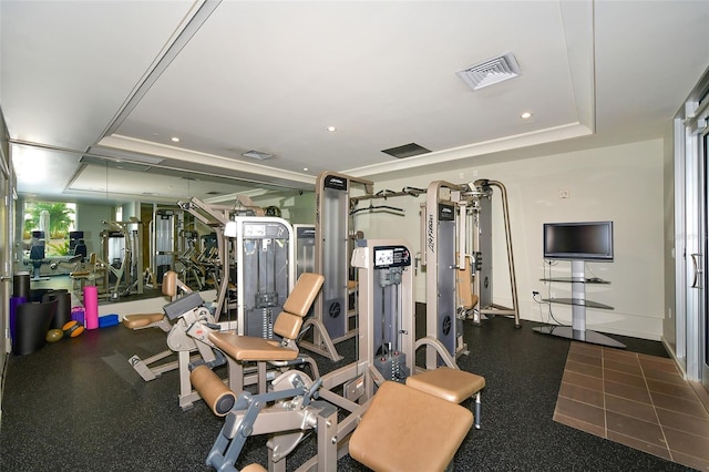 exercise room with a tray ceiling