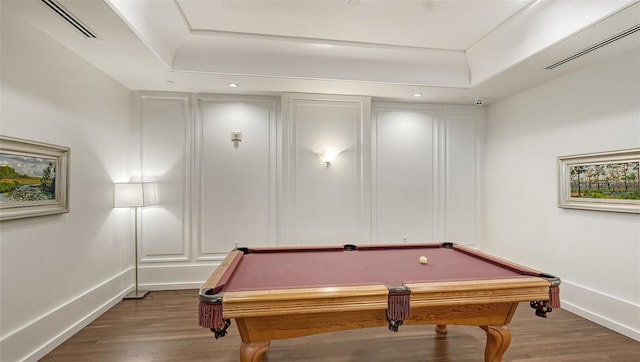 playroom featuring billiards, dark hardwood / wood-style floors, and a raised ceiling