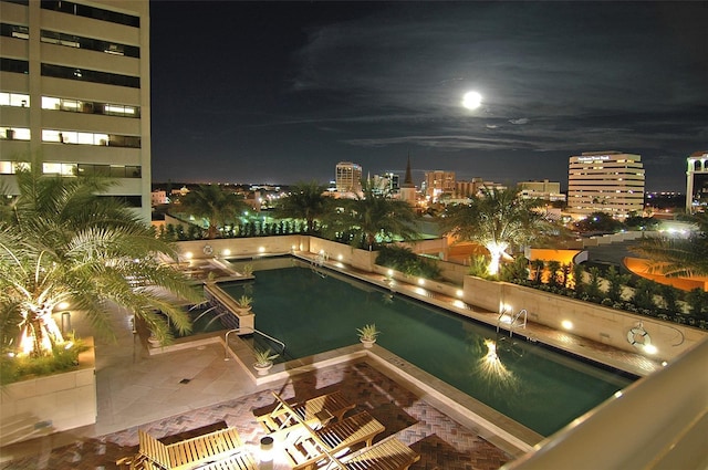 view of pool at night