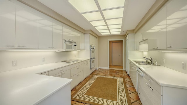 kitchen with white cabinetry, sink, and white appliances