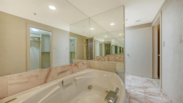 bathroom featuring shower with separate bathtub