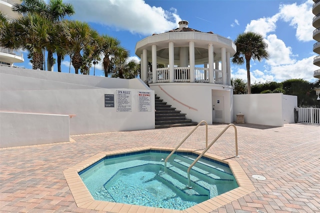 view of swimming pool featuring a community hot tub and a gazebo