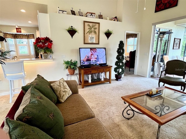 living room featuring carpet flooring and plenty of natural light