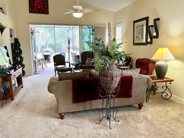 living room featuring high vaulted ceiling, light colored carpet, and ceiling fan