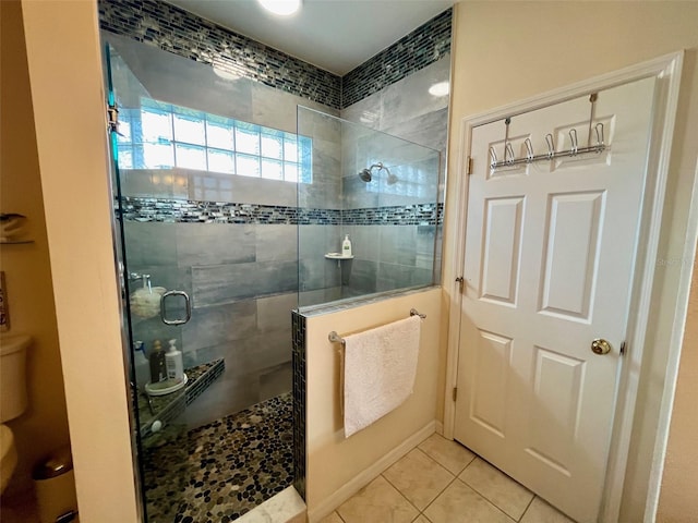 bathroom featuring tiled shower and tile patterned floors