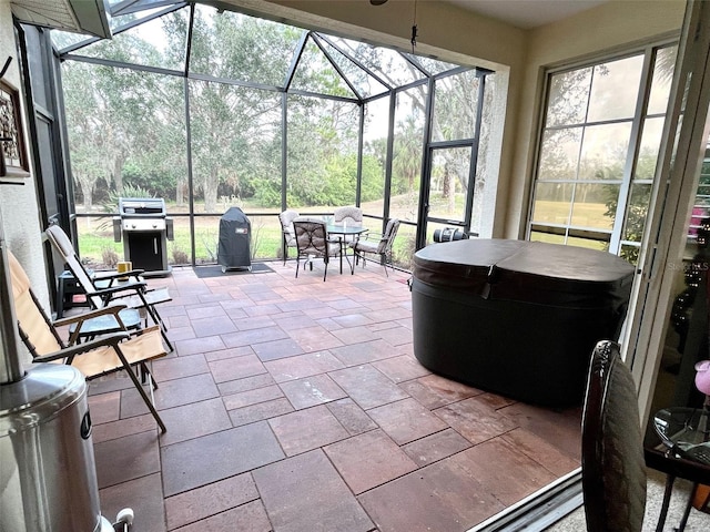 view of patio featuring a grill and a lanai