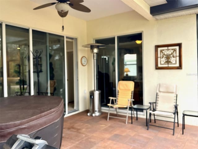 view of patio / terrace featuring ceiling fan and a hot tub