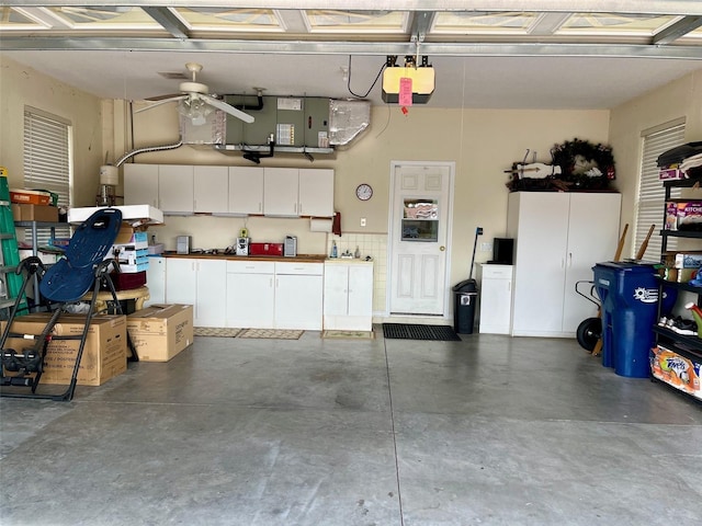 garage with ceiling fan and a garage door opener