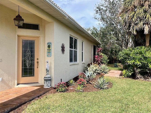 entrance to property with a yard