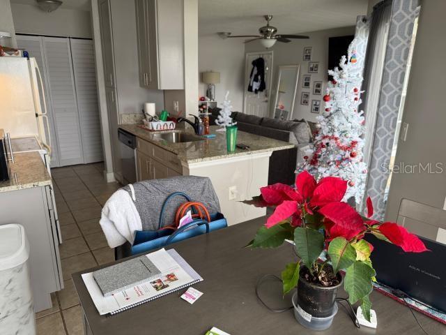 kitchen featuring white refrigerator, sink, stainless steel dishwasher, and light tile patterned floors