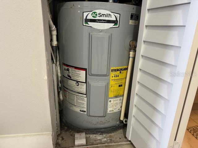 utility room featuring electric water heater