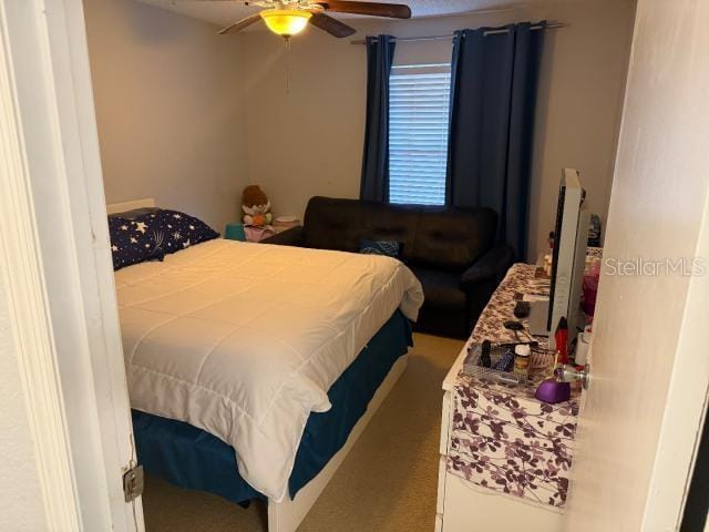 carpeted bedroom featuring ceiling fan