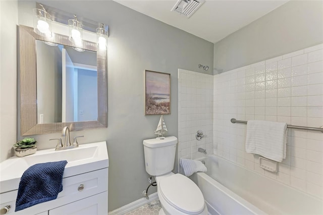 full bathroom with tiled shower / bath, vanity, and toilet