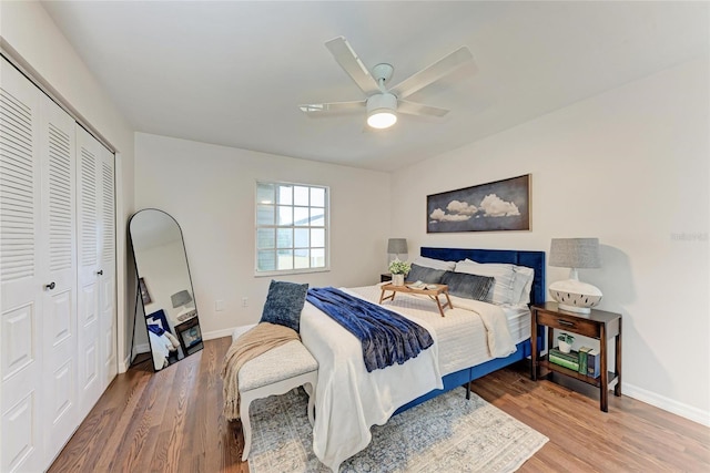 bedroom with wood-type flooring, ceiling fan, and a closet