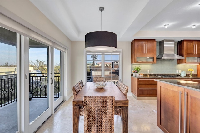 dining space with french doors and a tray ceiling