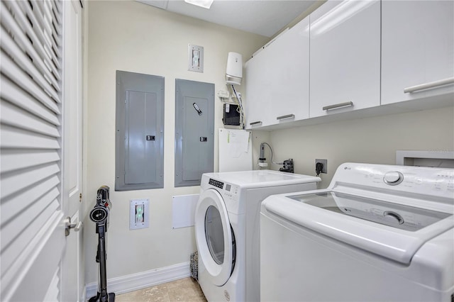 laundry area featuring cabinets, separate washer and dryer, and electric panel