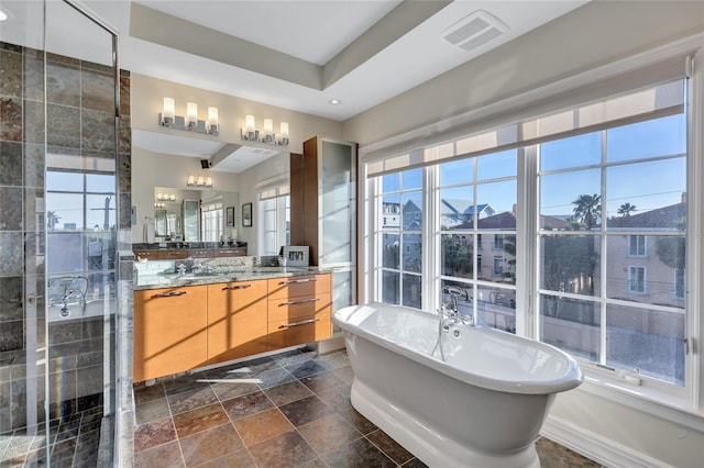 bathroom featuring vanity and shower with separate bathtub