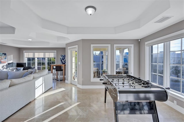 playroom with a raised ceiling