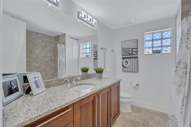 bathroom featuring vanity, toilet, and tile patterned flooring