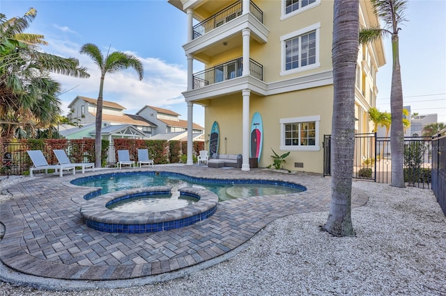 view of swimming pool featuring a patio and an in ground hot tub