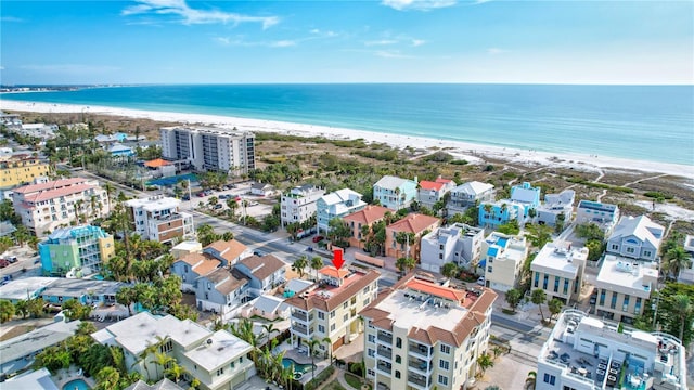 aerial view with a water view and a beach view