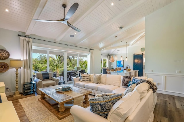 living room featuring wood ceiling, lofted ceiling with beams, hardwood / wood-style flooring, ceiling fan, and a barn door