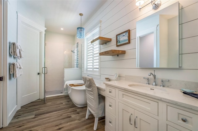 bathroom with vanity, hardwood / wood-style flooring, and independent shower and bath