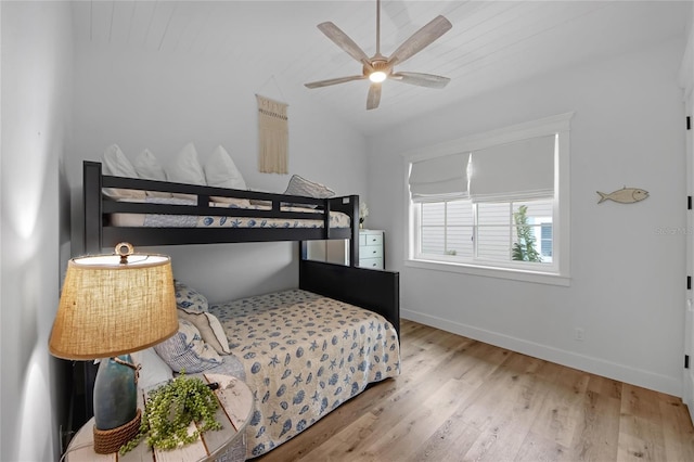 bedroom featuring ceiling fan, lofted ceiling, and light hardwood / wood-style floors