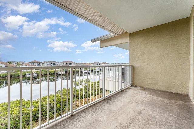 balcony featuring a water view and a residential view