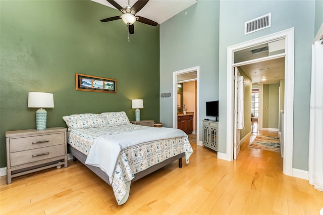 bedroom with light wood-style flooring, baseboards, and visible vents
