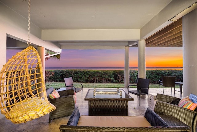 patio terrace at dusk featuring outdoor lounge area